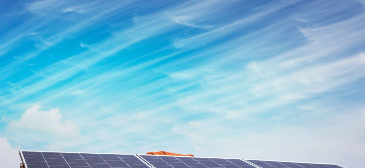 Solar panels on the red roof in a sunny and cloudy day. Photovol